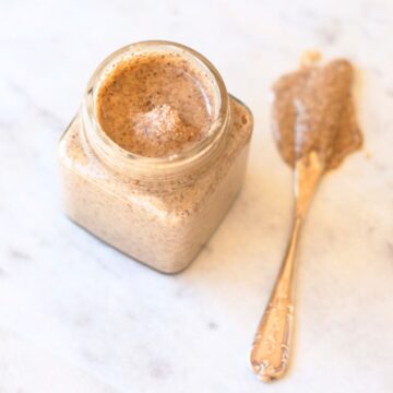 Image of almond butter in a jar with a knife.