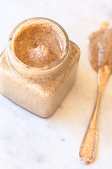 Image of almond butter in a jar with a knife.