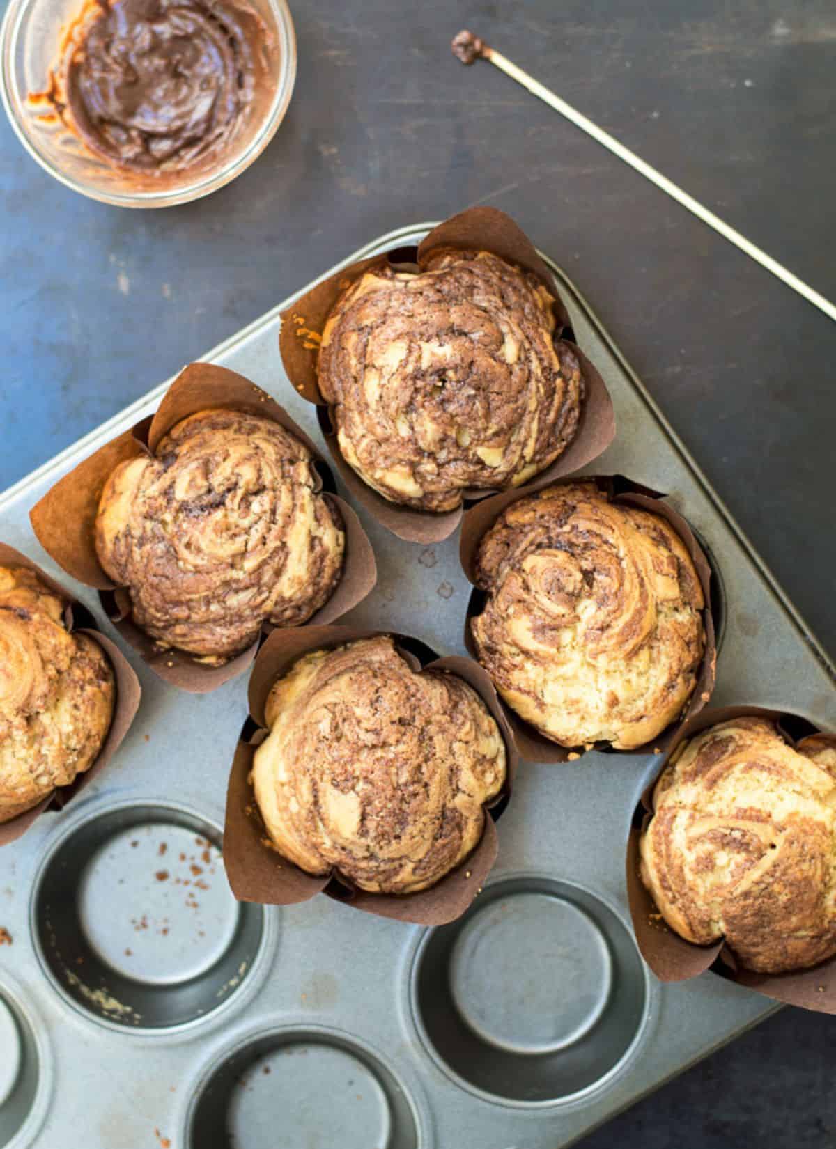 Overhead photo of nutella muffins in a baking tray.