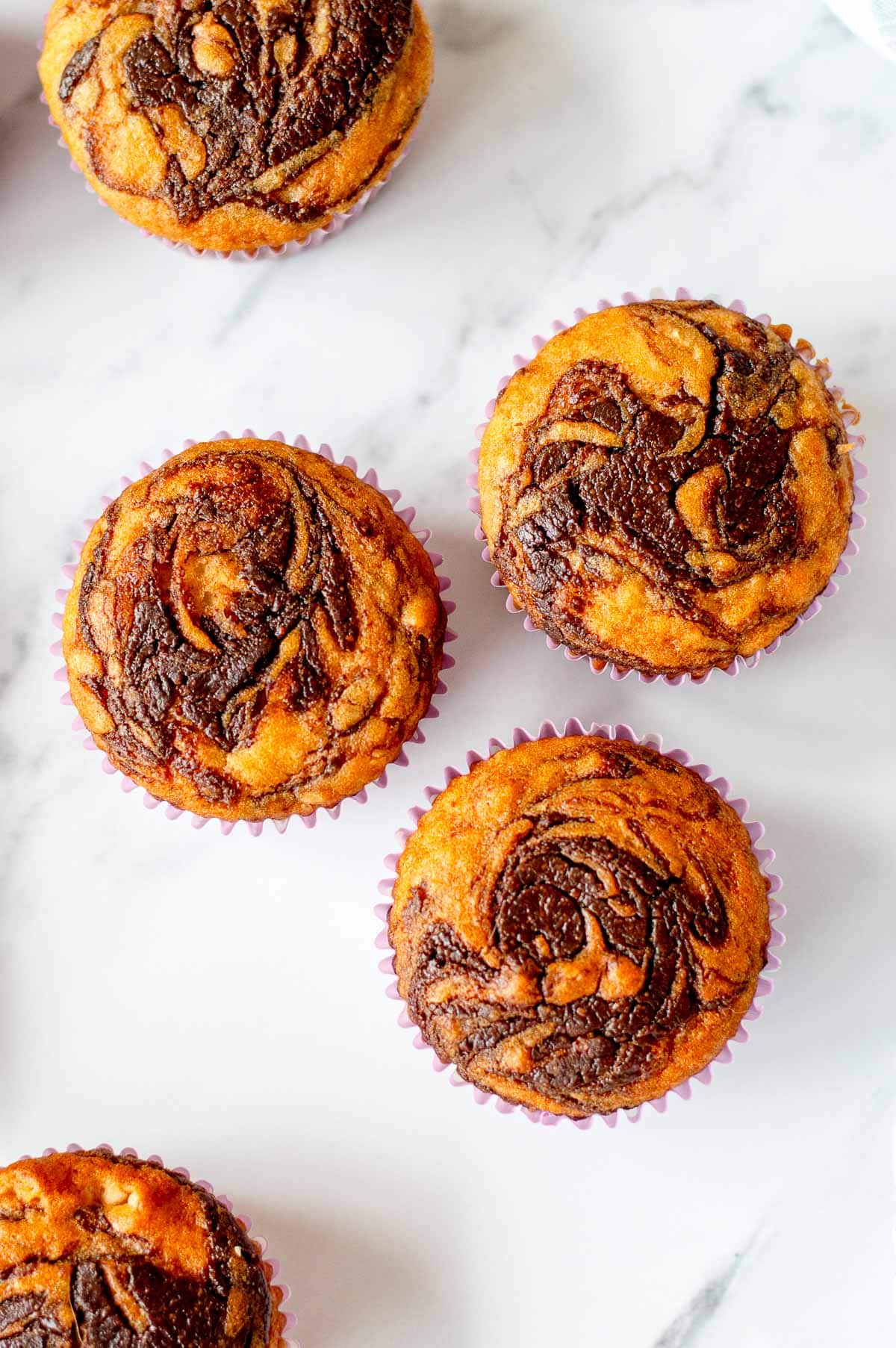 Overhead image of Nutella Muffins with a pretty nutella swirl on top.
