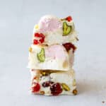 3 squares of white chocolate rocky road stacked on top of each other.