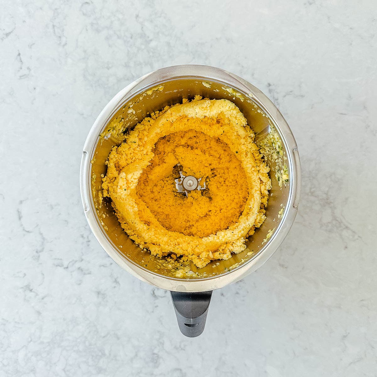 Frozen mango pieces in a Thermomix bowl.
