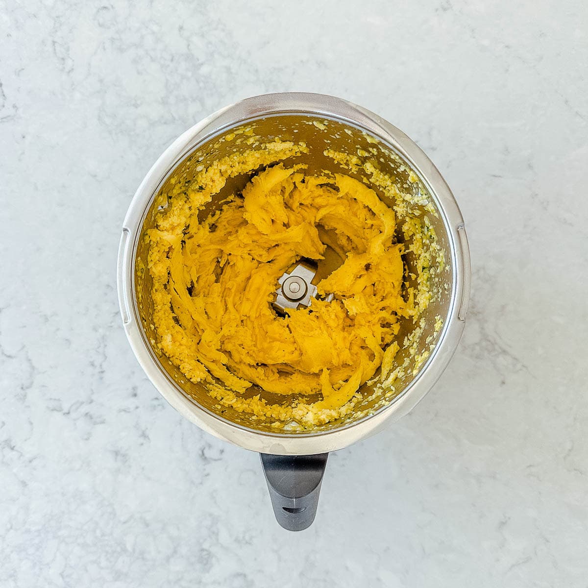 Mango sorbet in a Thermomix bowl.