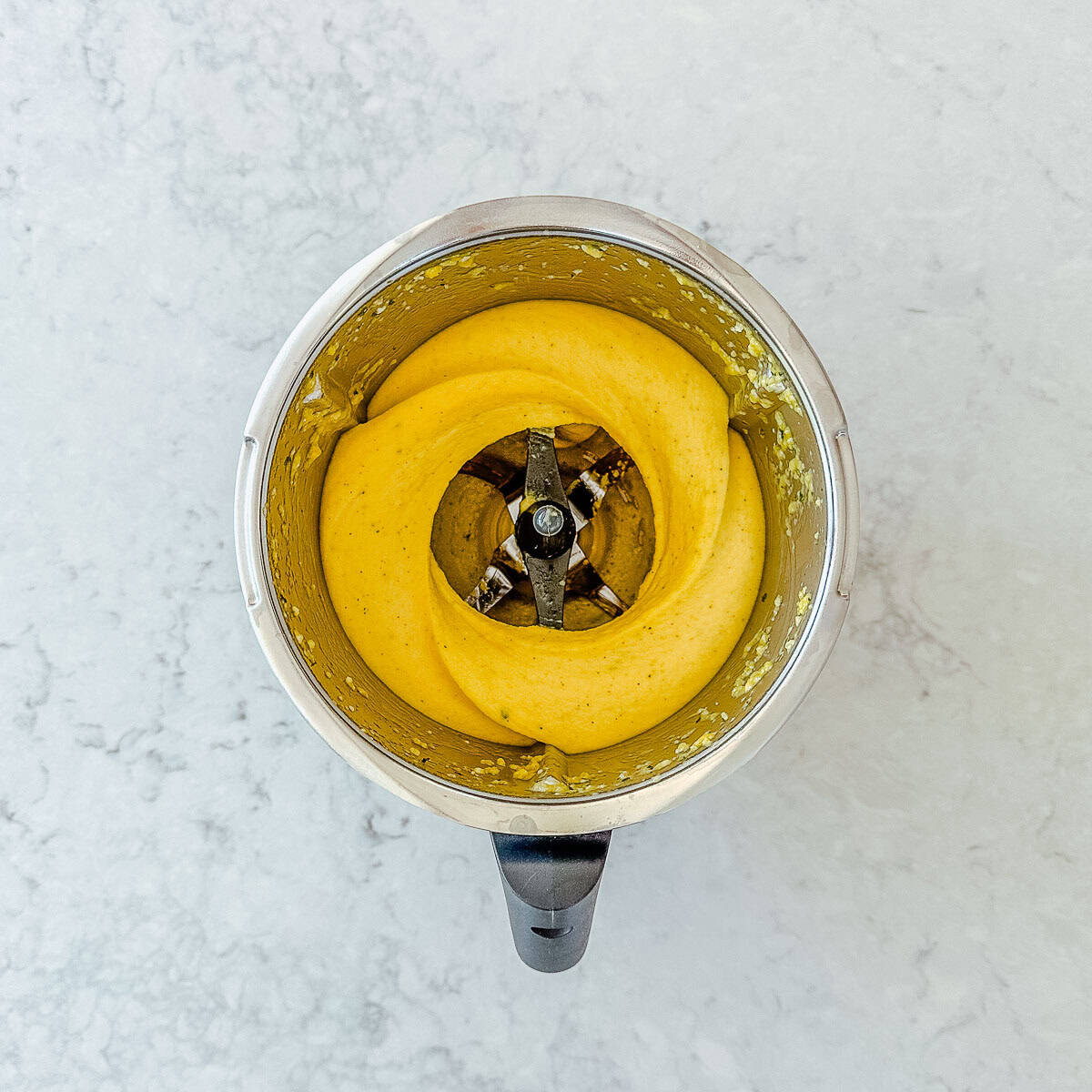 Creamy Mango Sorbet in a Thermomix bowl.