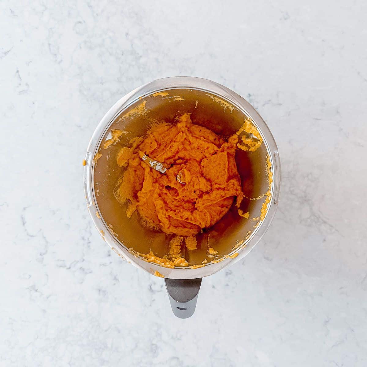 Blended vegetable stock concentrate in a thermomix bowl.