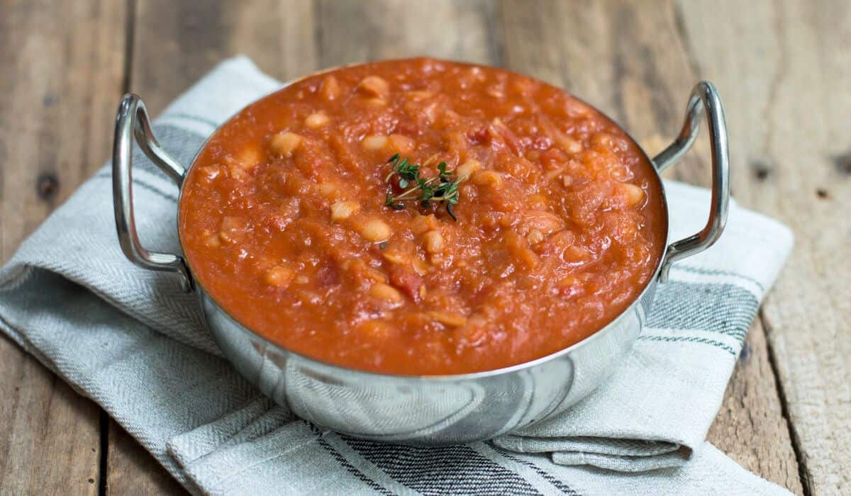 Homemade baked beans in a metal dish.