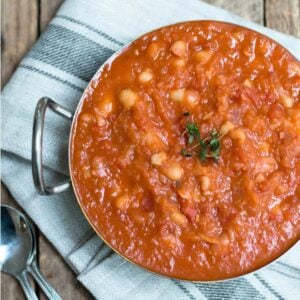 Homemade baked beans in a metal dish.