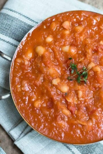 Homemade baked beans in a metal dish.