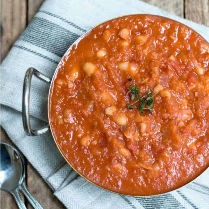 Homemade baked beans in a metal dish.