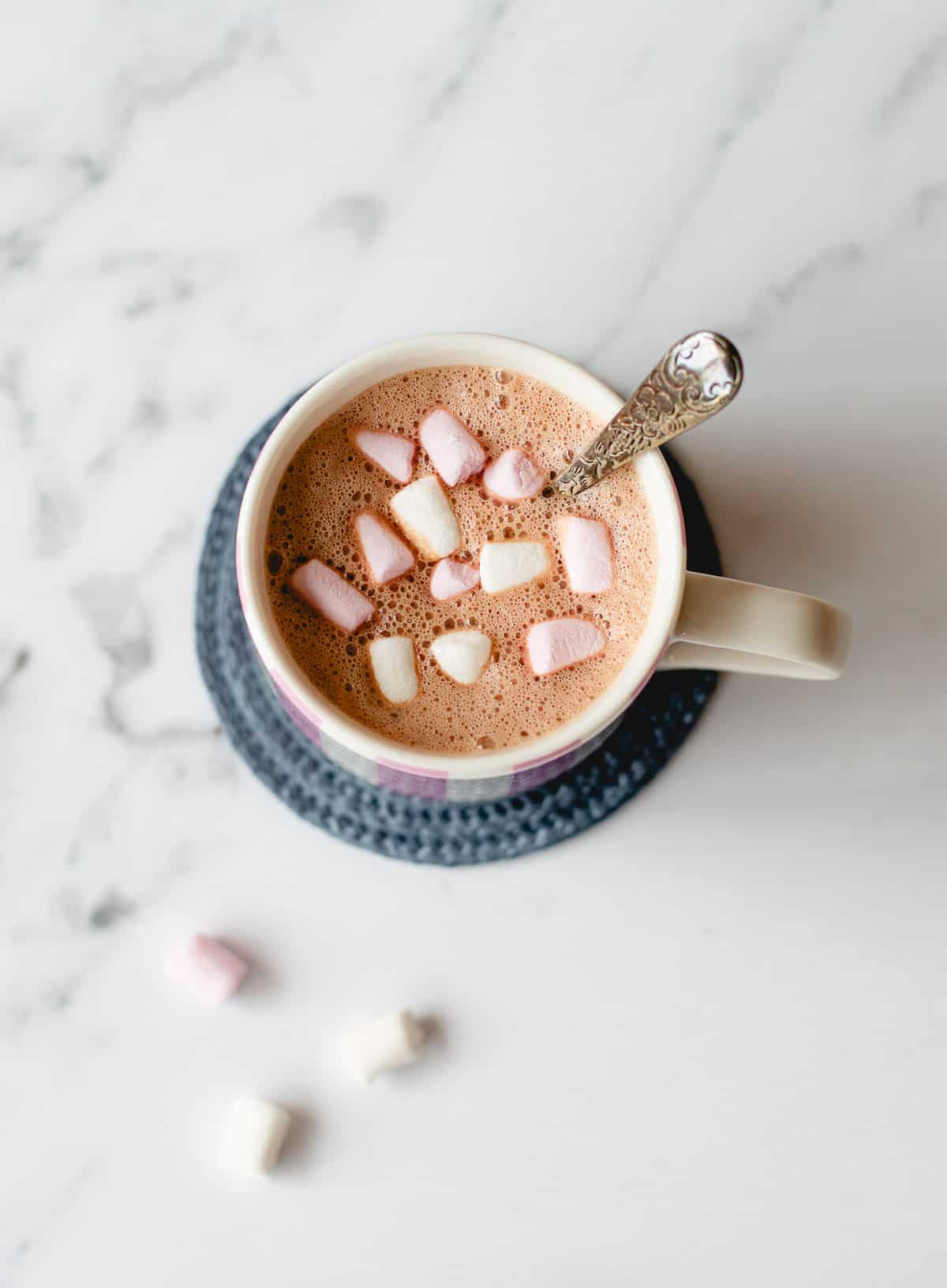 Overhead image of hot chocolate with mini Marshmallows in a white mug.