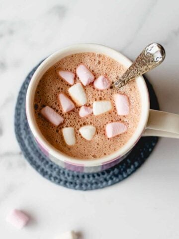 Hot chocolate and marshmallows in a white mug.