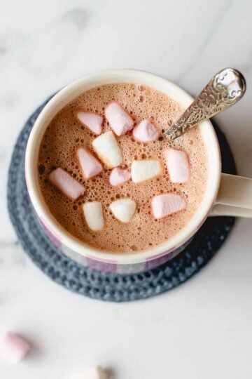 Hot chocolate and marshmallows in a white mug.