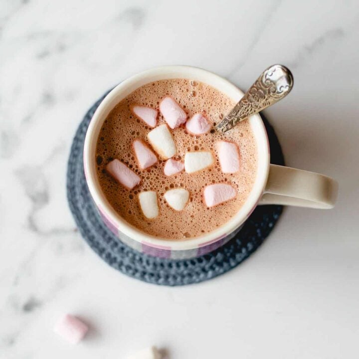 Hot chocolate and marshmallows in a white mug.