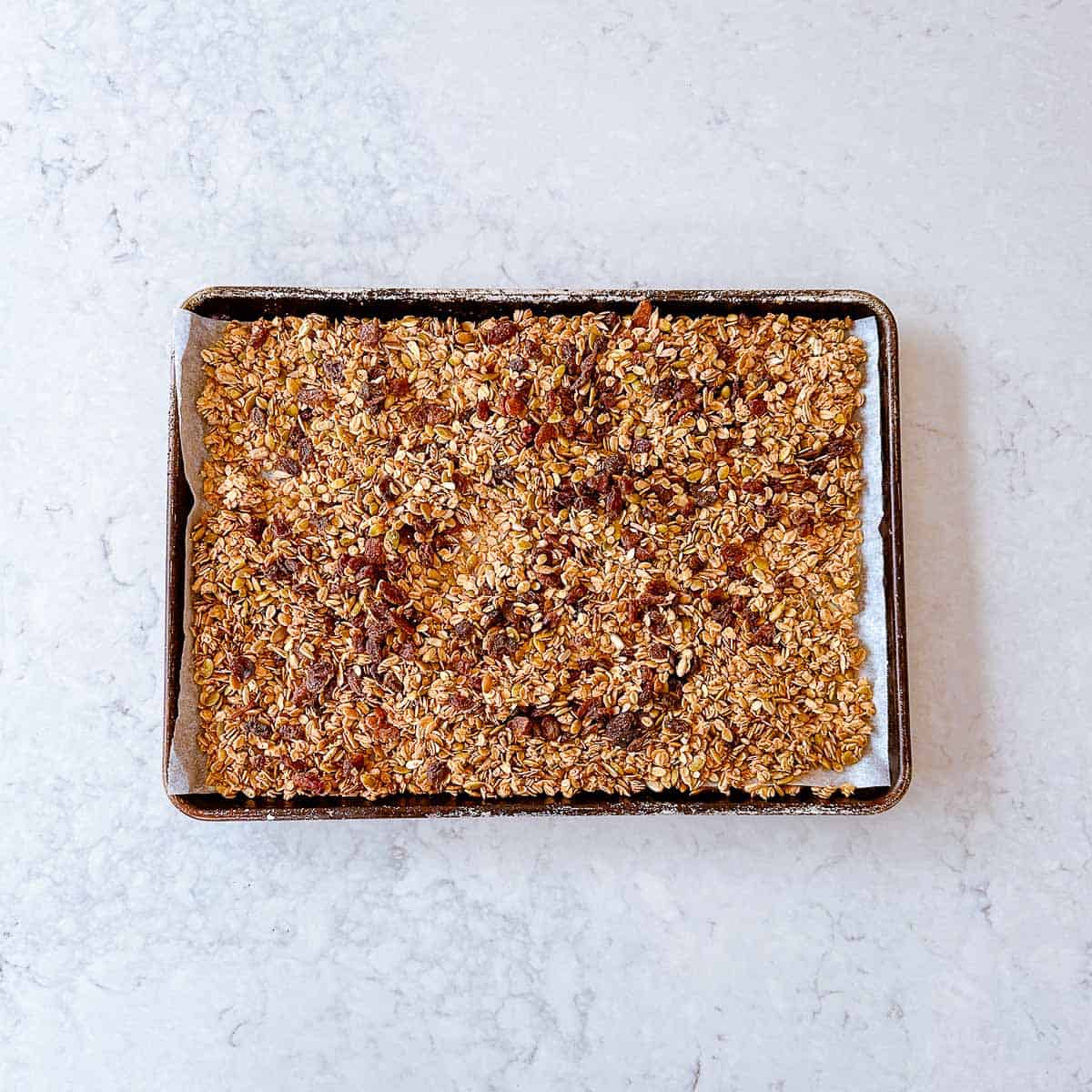 Homemade toasted Granola on a large baking tray.