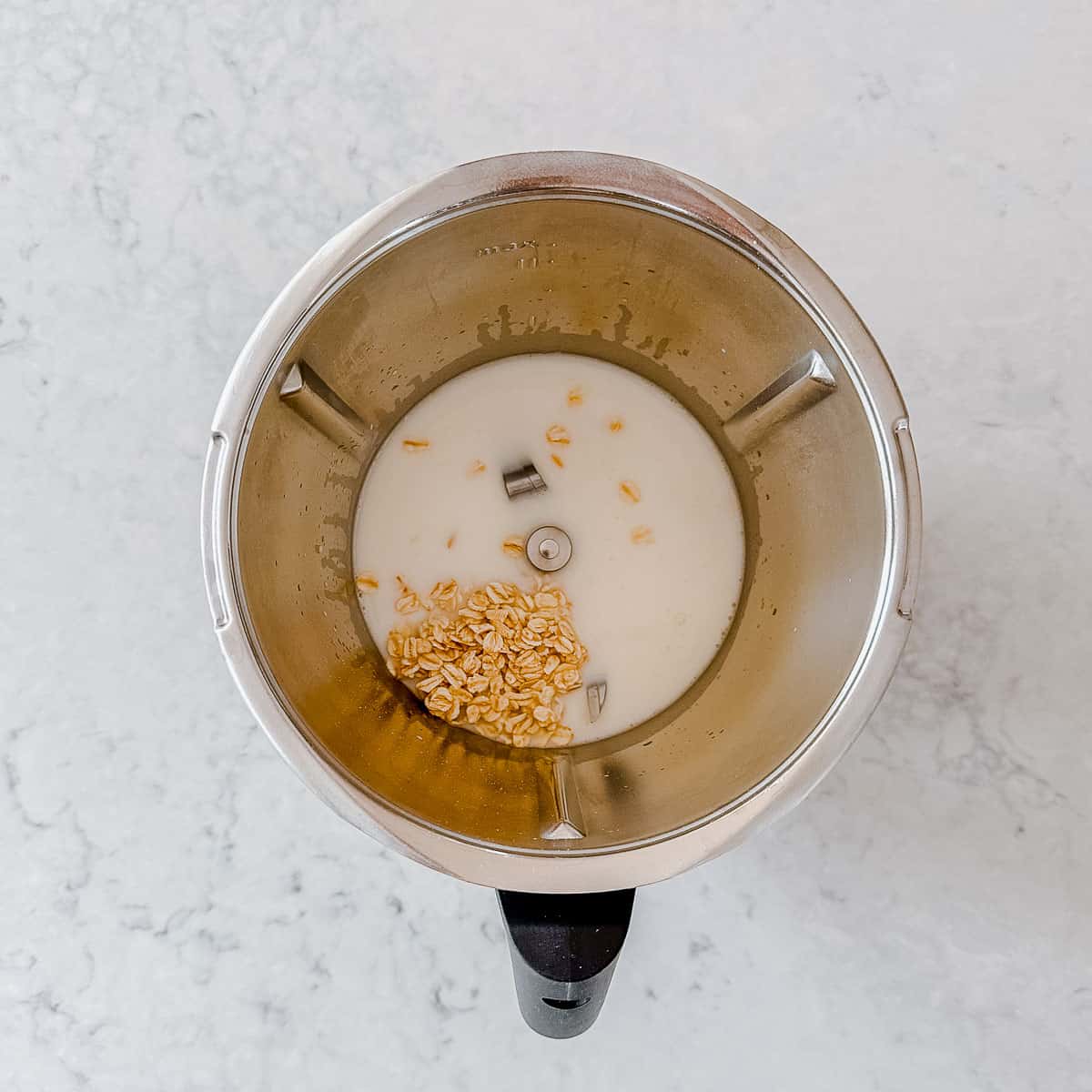 Porridge ingredients in a Thermomix bowl.