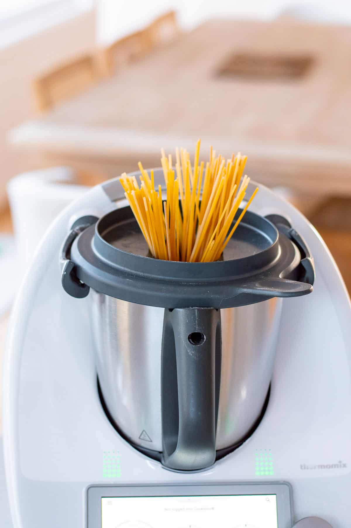 Spaghetti poking out of the top in a Thermomix.