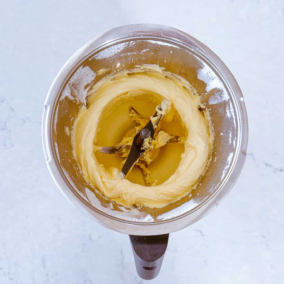 Butter and sugar creamed together in a Thermomix bowl.