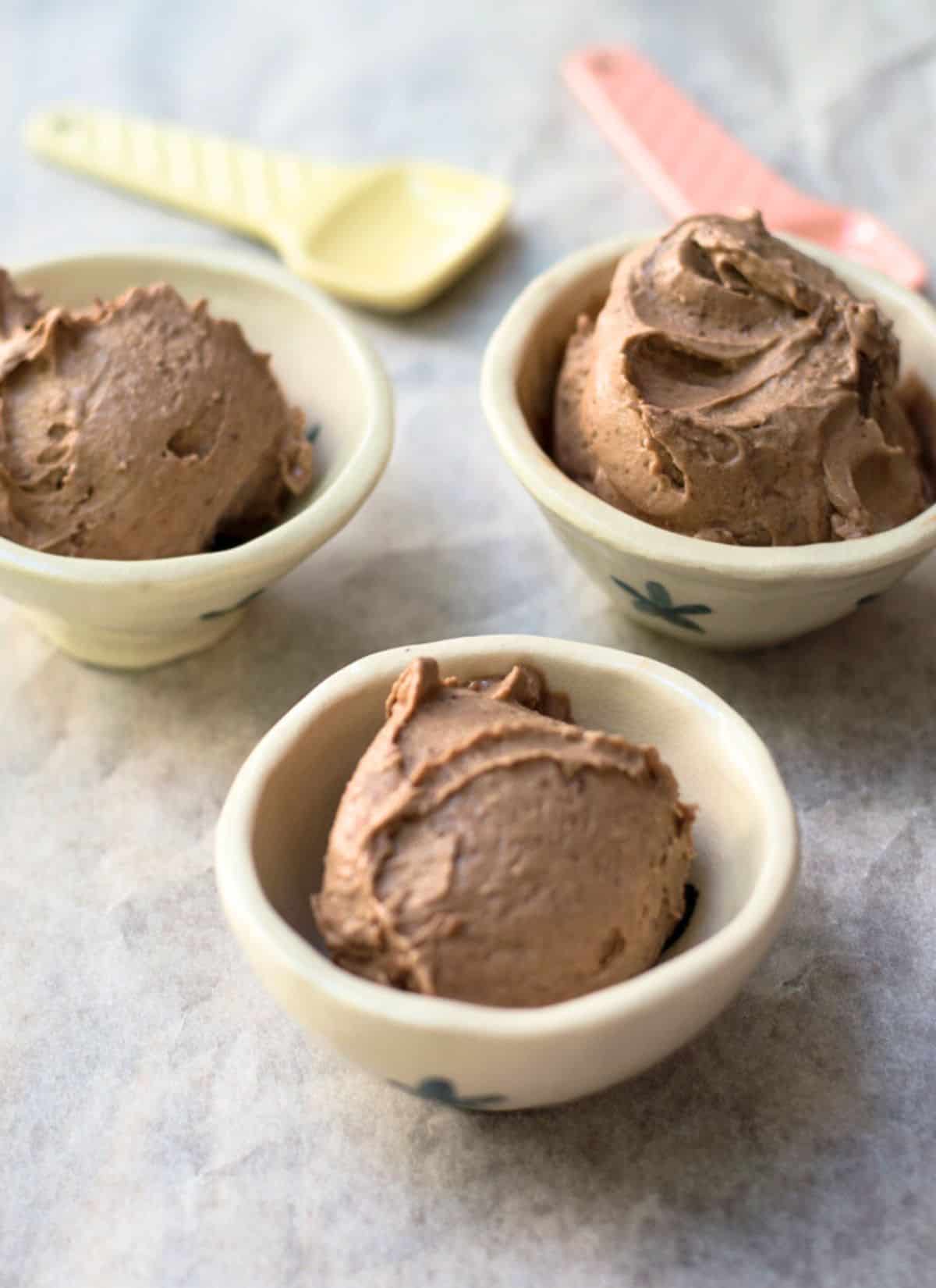 Nutella Ice Cream in 3 small bowls on a grey background.