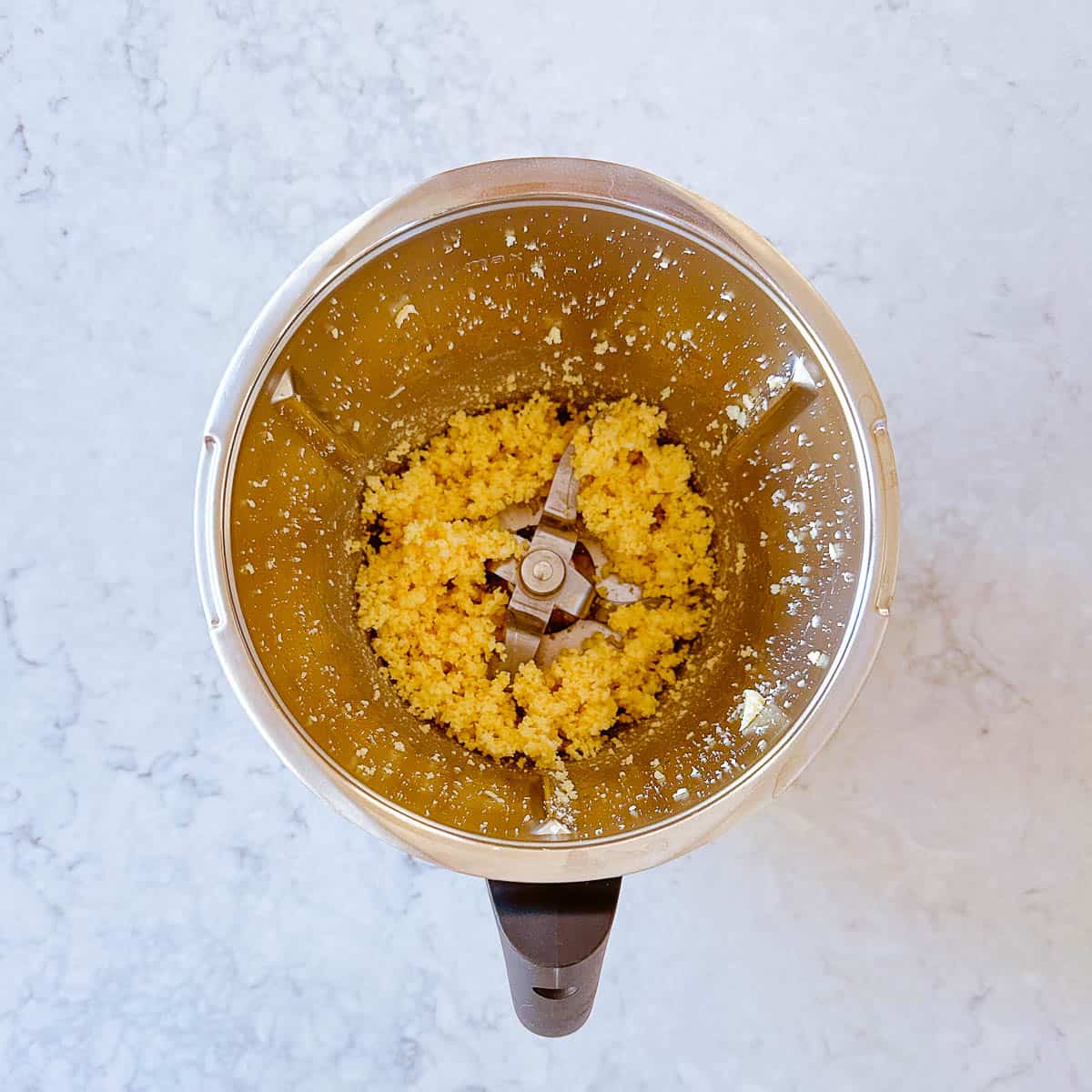 Grated cheese in a Thermomix bowl.