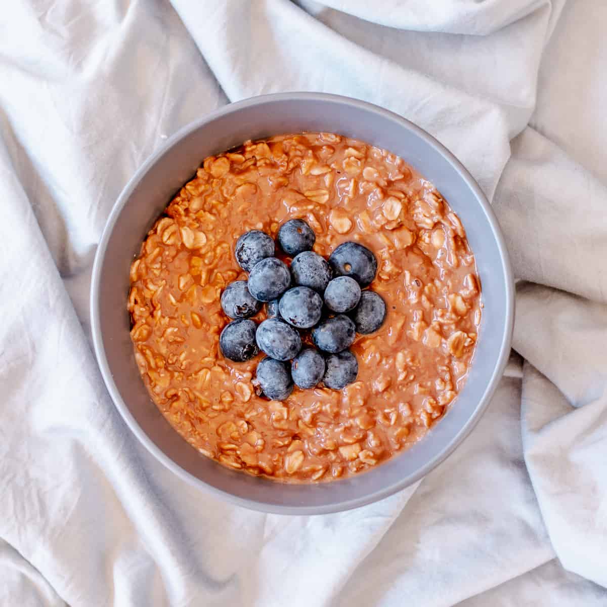 Chocolate Porridge in grey bowl with blueberries