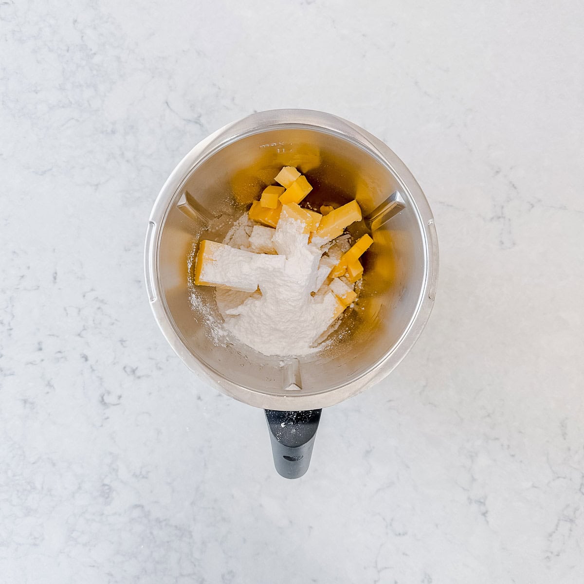 Butter and icing sugar in a Thermomix bowl.