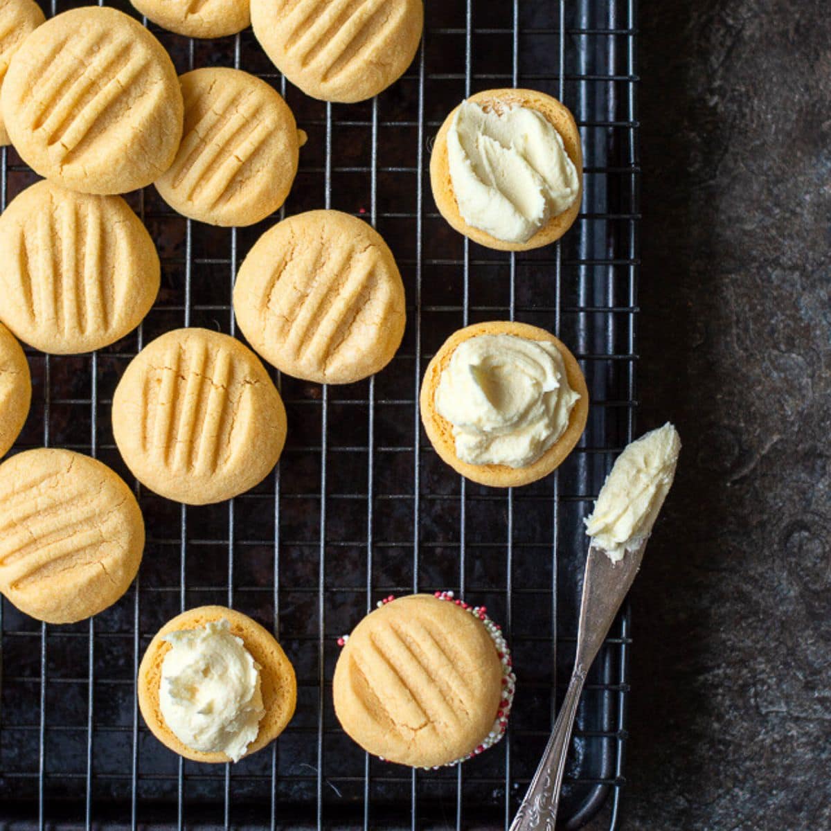 Buttercream spread over one half of melting moments biscuits.