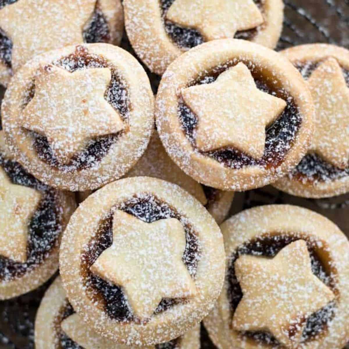 Starred mince pies with a dusting of icing sugar on them.