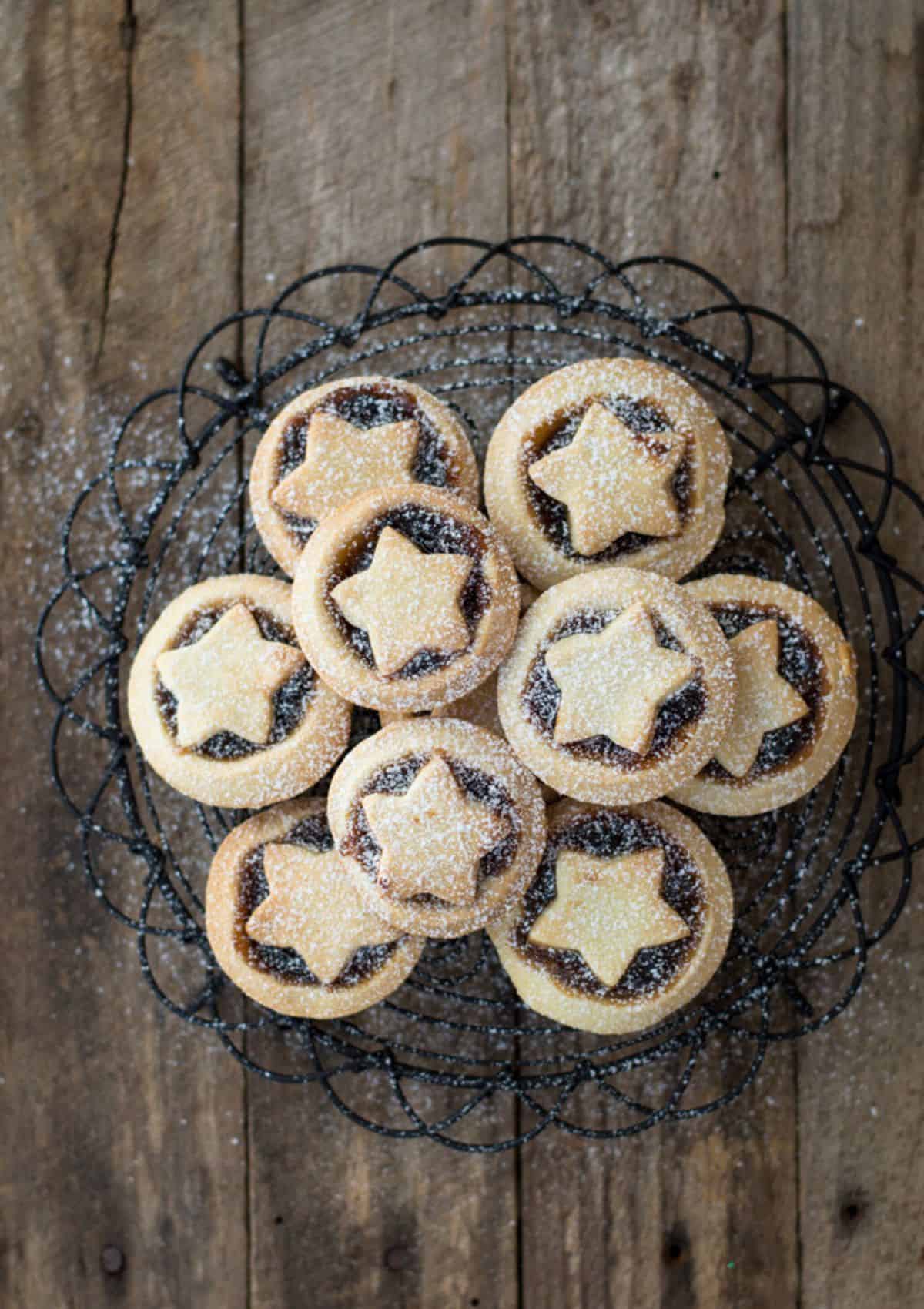 Mini Mince Pies with Stars on a wire baking rack.