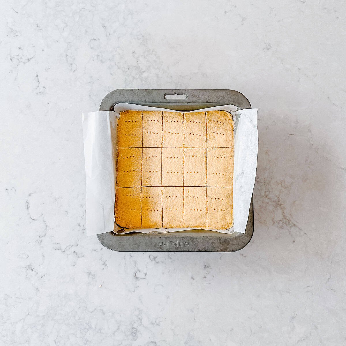Cooked Shortbread in a square tin.