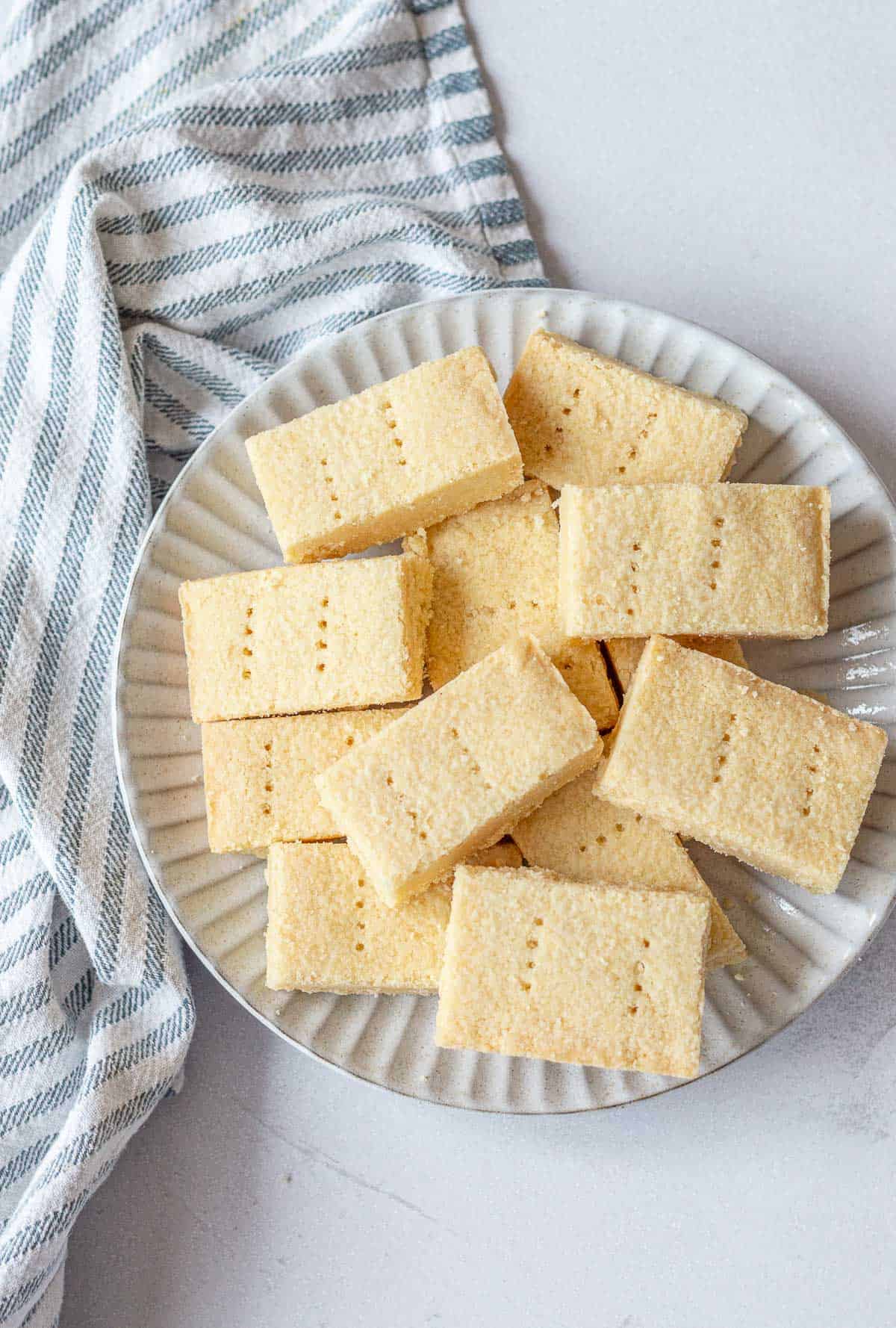A plate of shortbread rectangles, sitting on a white background.