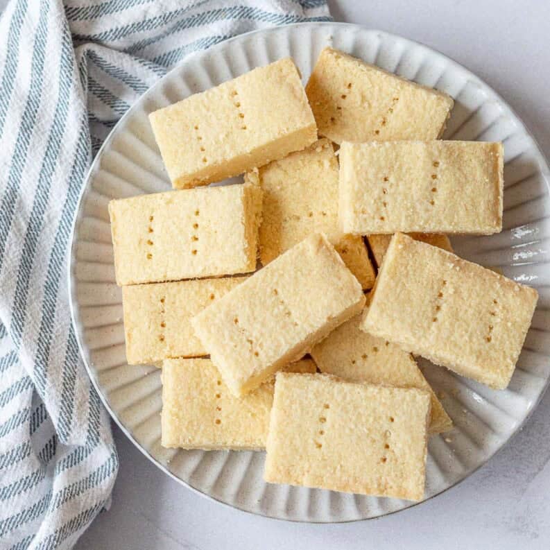 A plate of shortbread rectangles on a light coloured background.