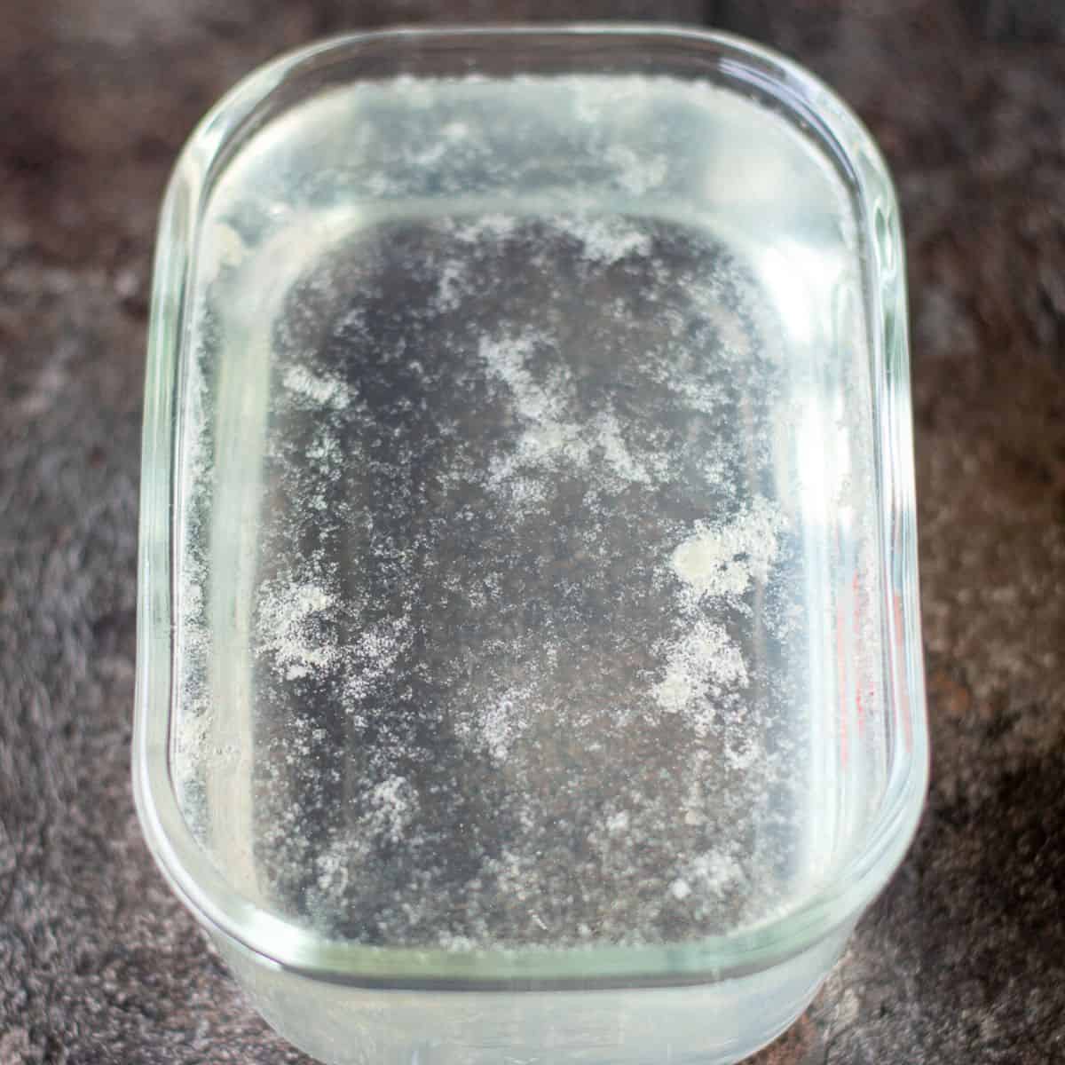 Glass container with sugar syrup and lemon juice in it.