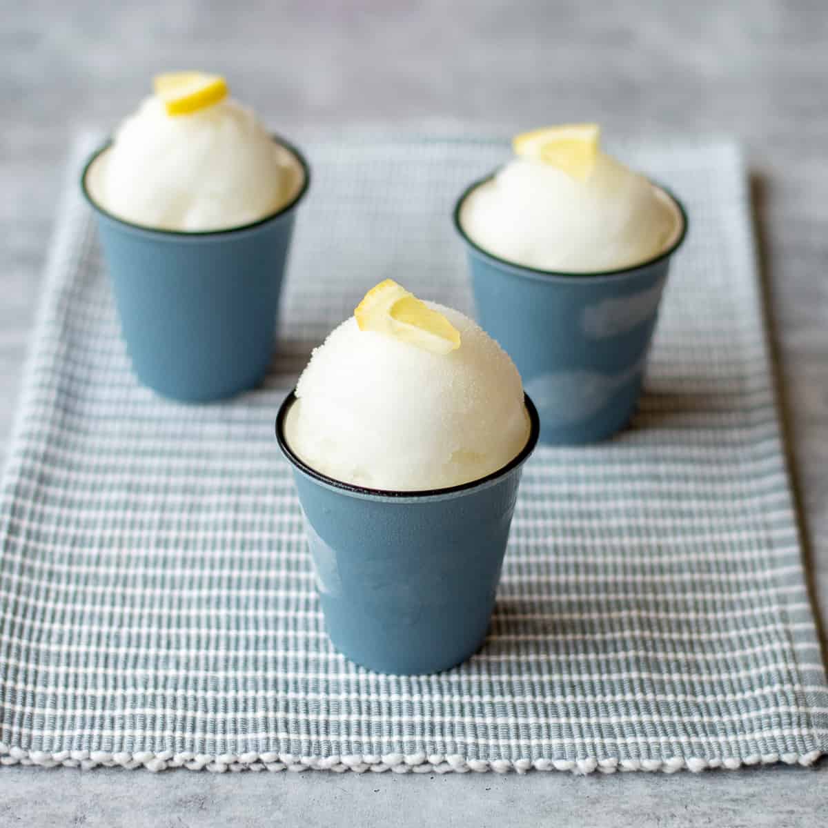 3 gin and tonic sorbets garnished with lemon wedges