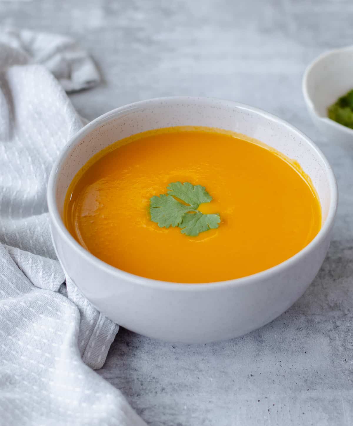 Carrot and Coriander Soup in a grey bowl.