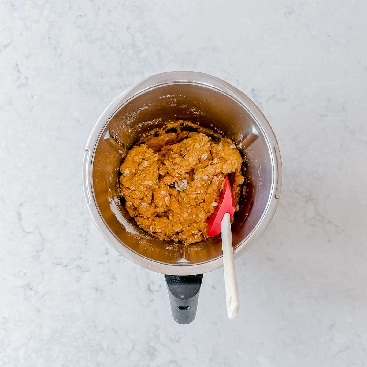 Anzac biscuit dough in a Thermomix bowl.