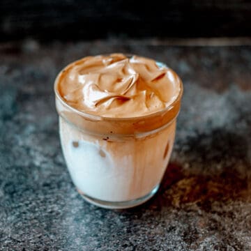 A close of image of whipped coffee in a glass.