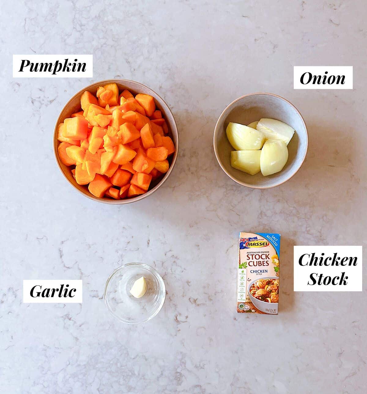 A collection of ingredients needed to make Pumpkin Soup.