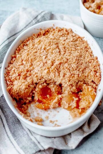 Apricot Crumble in a white oval dish on grey background