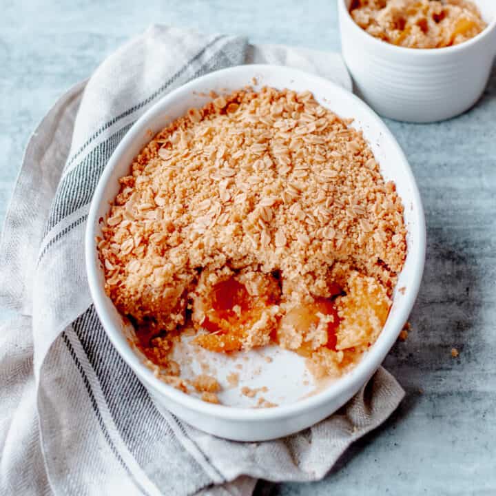 Apricot Crumble in a white oval dish on grey background