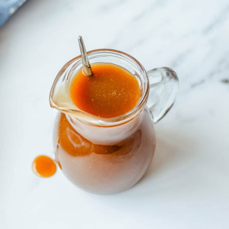 Butterscotch sauce in a glass jug.