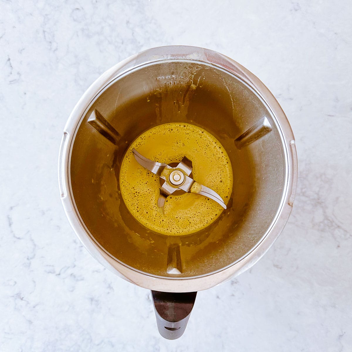 Frothy matcha latte in a thermomix jug.