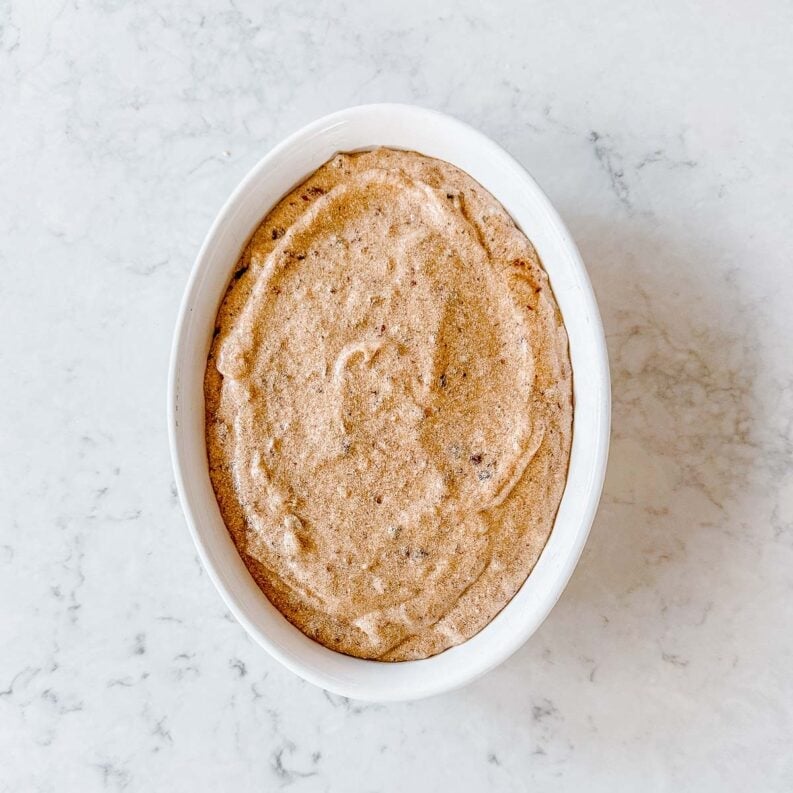 Sticky Date Pudding batter in a white oval dish.