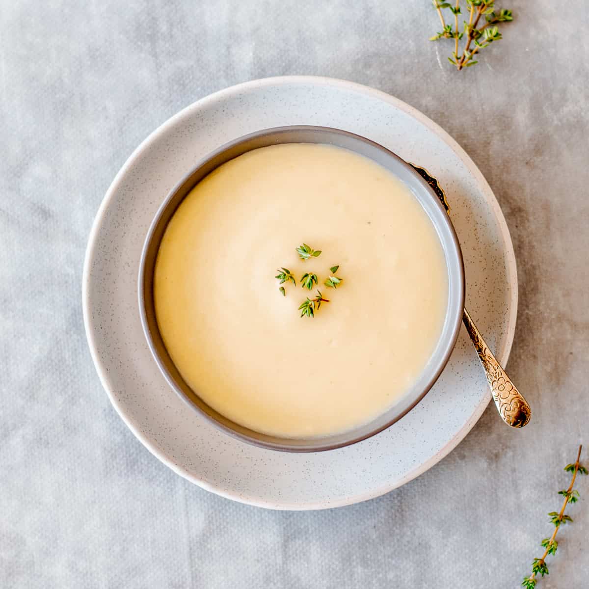 An overhead image of a bowl of Thermomix Celeriac, Parsnip and Thyme Soup