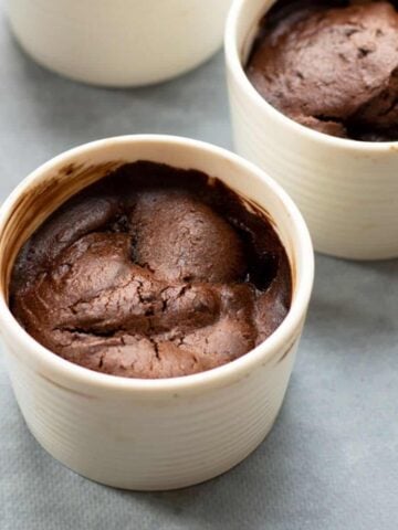 Close up of chocolate pear pudding in white ramekin
