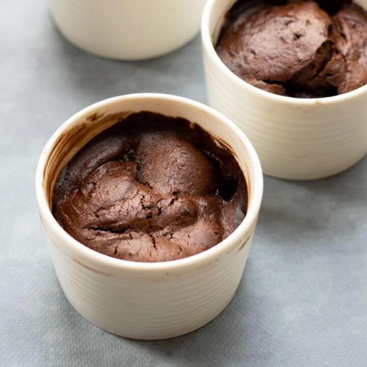 Close up of chocolate pear pudding in white ramekin