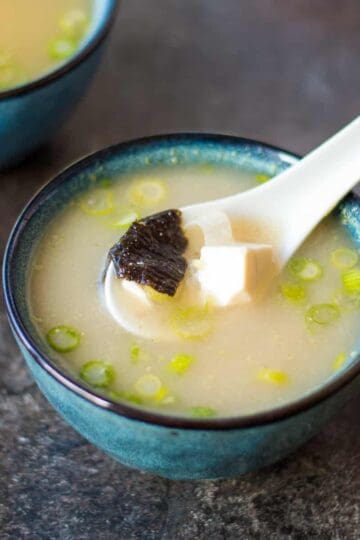 A bowl of miso soup with nori and tofu