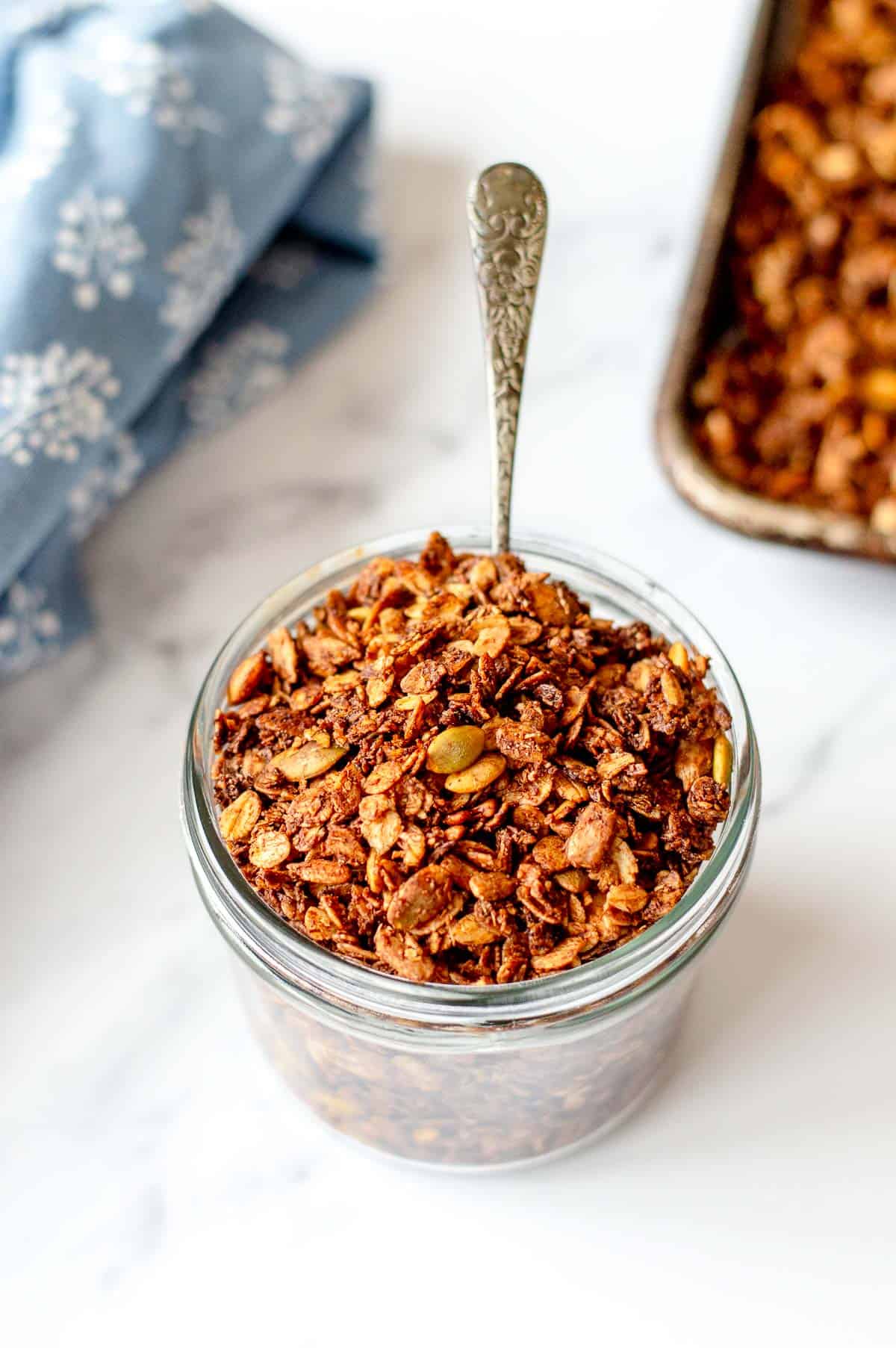 Chocolate Granola in a glass jar.