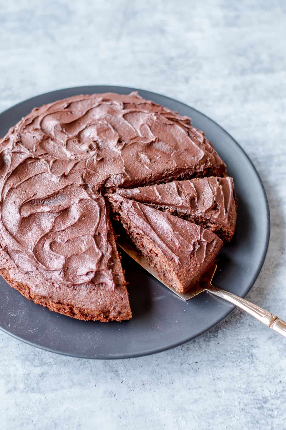 Chocolate Cake covered in Chocolate Buttercream Icing cut into Slices