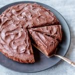 Chocolate Cake Covered in Chocolate Buttercream Icing Cut into Slices
