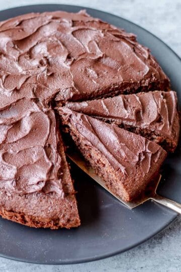 Chocolate Cake Covered in Chocolate Buttercream Icing Cut into Slices